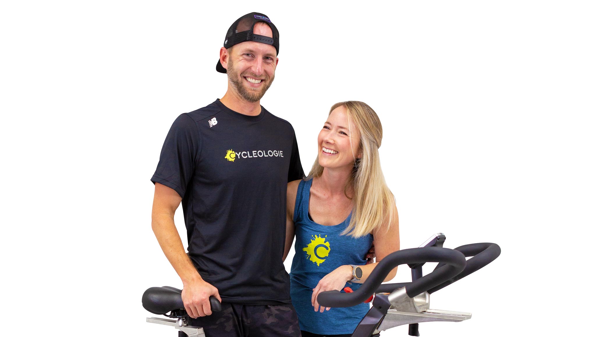Chris and Kendra standing behind a stationary bike.
